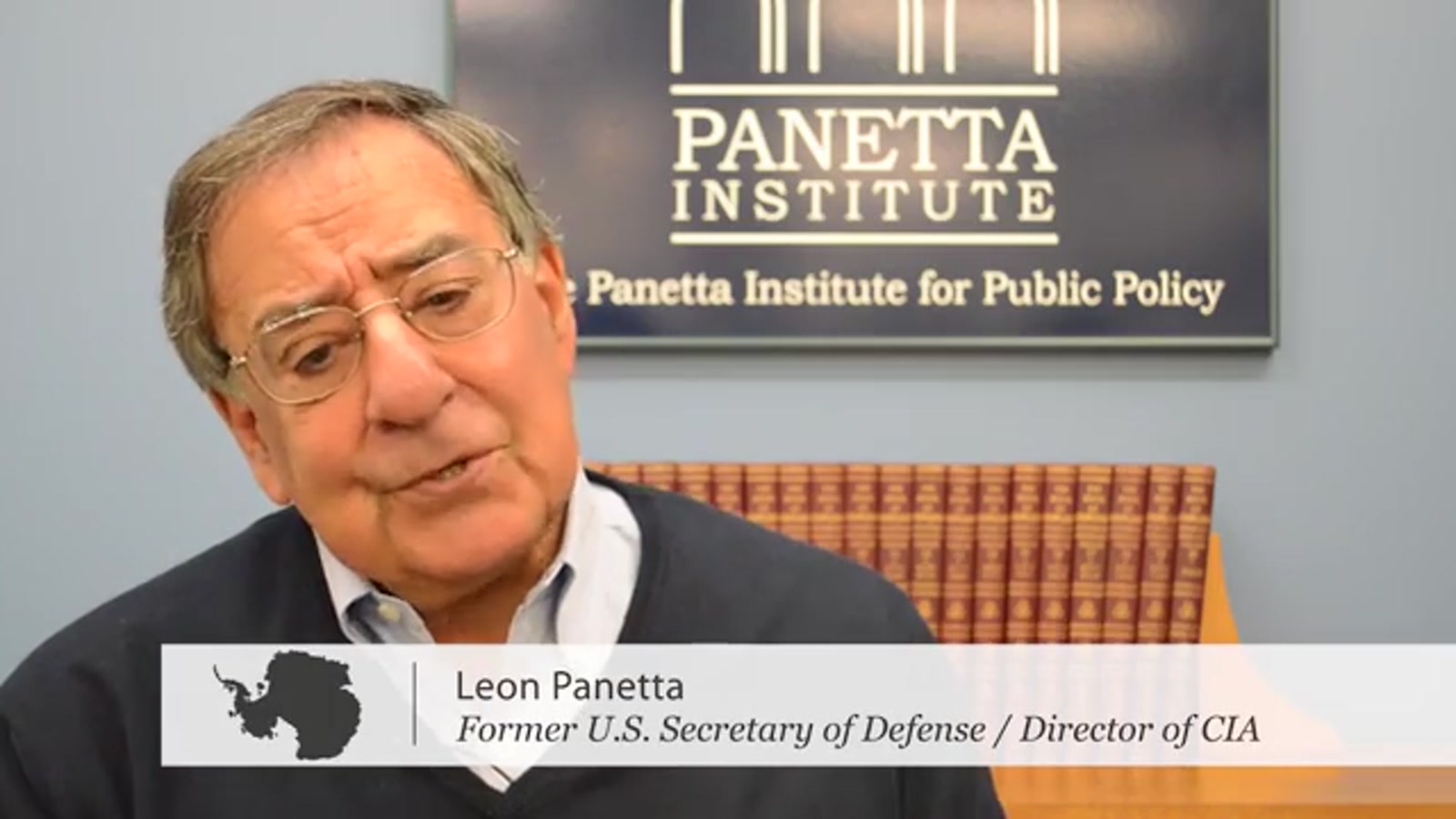 Leon Panetta mid-interview in front of a Panetta Institute for Public Policy backdrop, with the film’s lower-third reading “Leon Panetta — Former U.S. Secretary of Defense / Director of CIA”